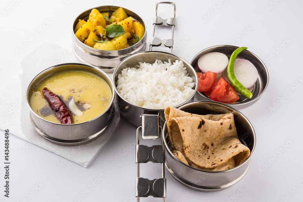 indian typical stainless steel lunch box or tiffin with north indian or  maharashtrian food menu like