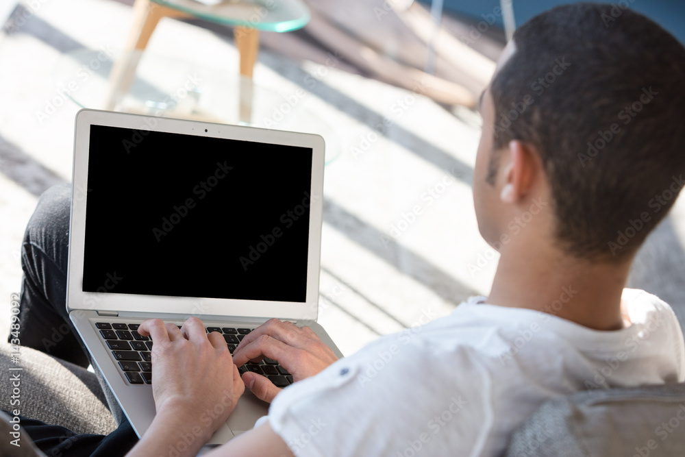 Incognito man typing on laptop Incognito man typing on laptop