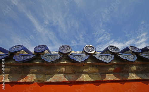 The blue glazed tiles on the wall as the background, the traditional architecture