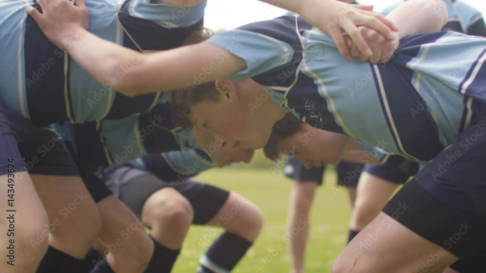 Young team players in a scrum at rugby match Young team players in a scrum at rugby match