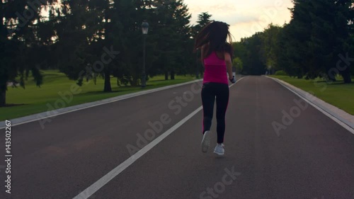 Wallpaper Mural Woman running away in park. Young woman running at morning. Morning fitness training. Female jogger in park. Fitness woman running on road. Running woman in slow motion. Torontodigital.ca