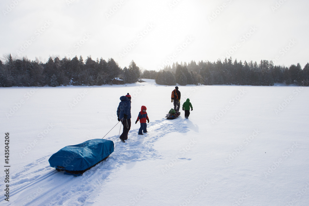 Mixed race family going ice fishing