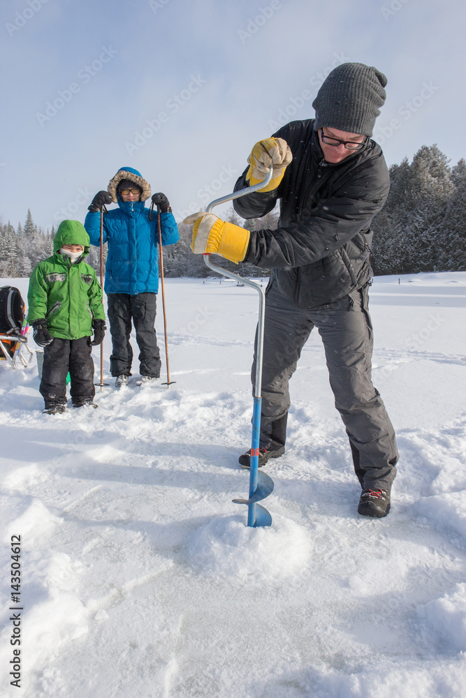 Mixed race family ice fishing