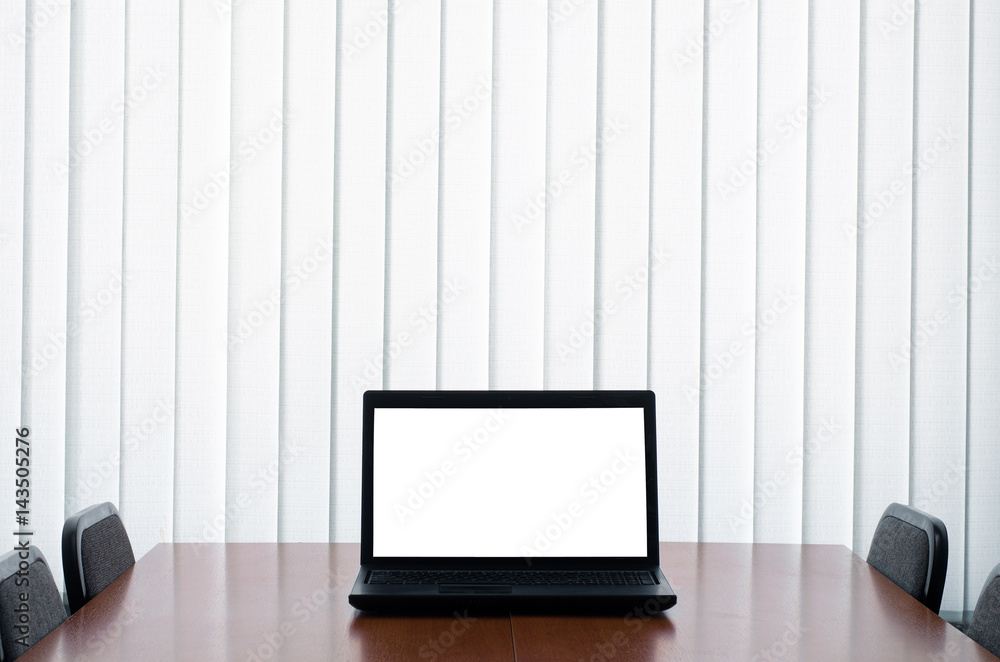 Laptop with blank screen on wooden table in office. Business , presentation or business meeting concept. Laptop with blank screen on wooden table in office. Business , presentation or business meeting concept.