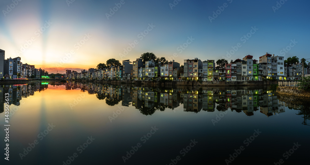 Hanoi cityscape at sunset. Resident buildings by Tien Bien lake, Gia Lam district Hanoi cityscape at sunset. Resident buildings by Tien Bien lake, Gia Lam district