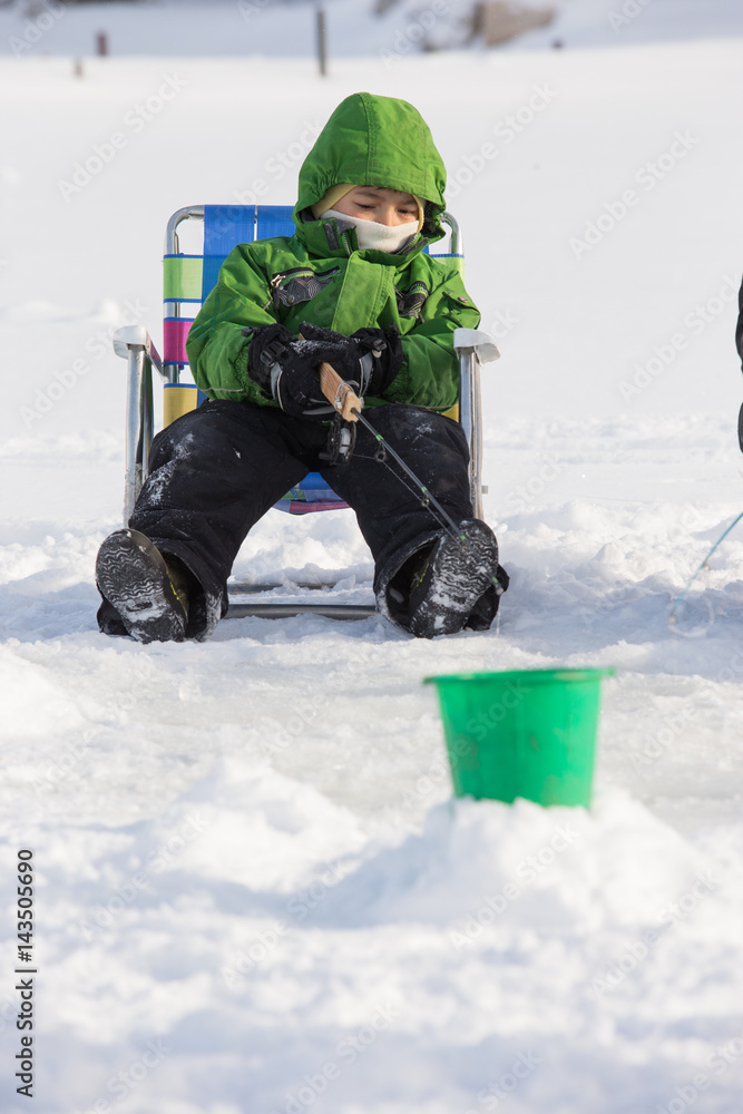 Little boy ice fishing