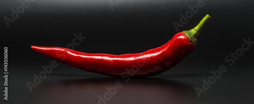 Leinwand Poster Red chili pepper isolated on black background with selective focus