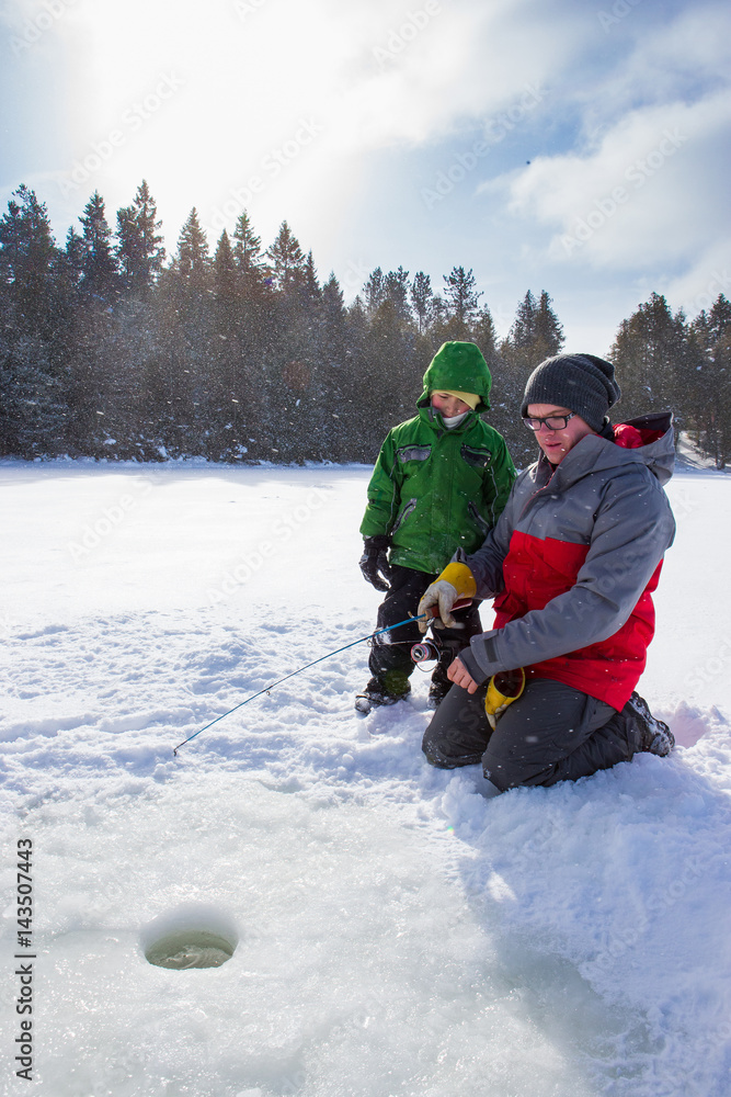 Mixed race family ice fishing
