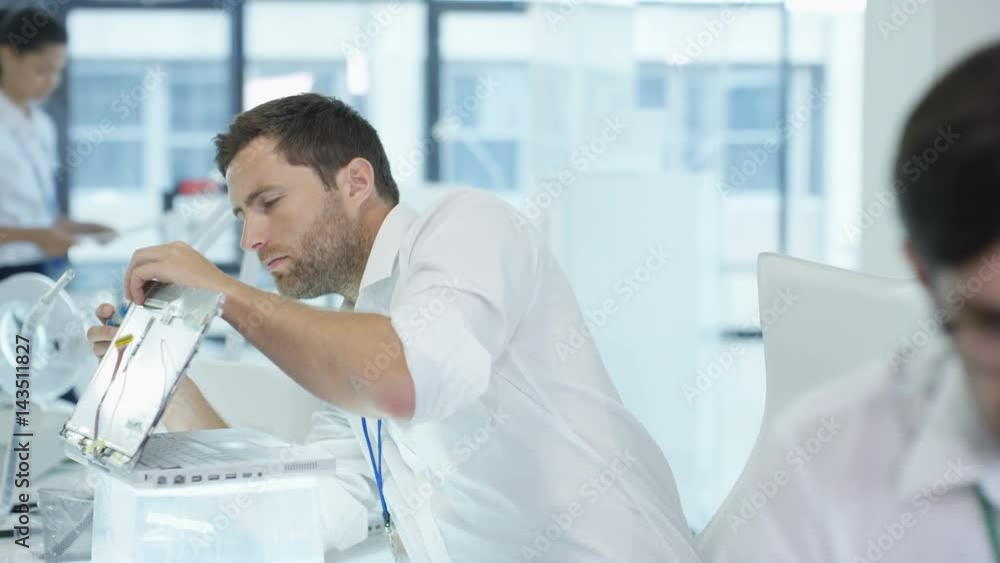 Electronics engineers working in lab building & testing electronic devices Electronics engineers working in lab building & testing electronic devices