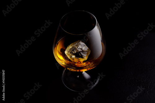 whisky drink with ice on black background.