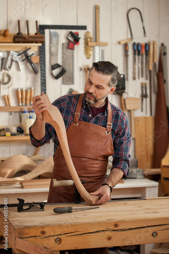 Joiner Makes Cabriole Leg for Vintage Table/Carpenter works with a planer in a workshop for the production of vintage furniture. He makes cabriole leg for a table in the style of Louis XV
