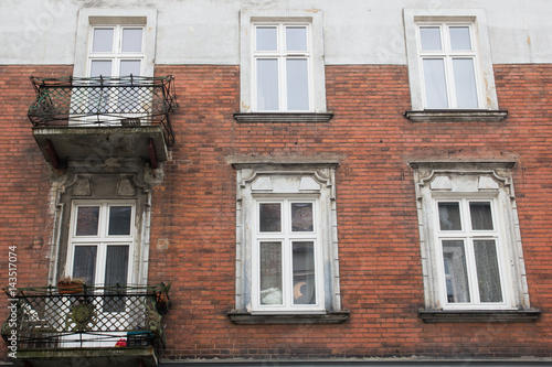 Vintage design windows with a balcony on the facade of the old house