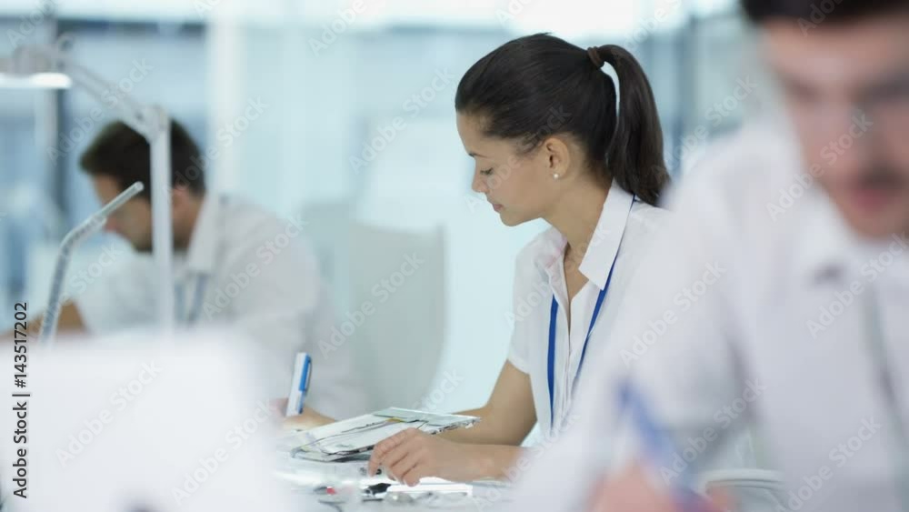 Electronics engineers working in lab building & testing electronic devices Electronics engineers working in lab building & testing electronic devices