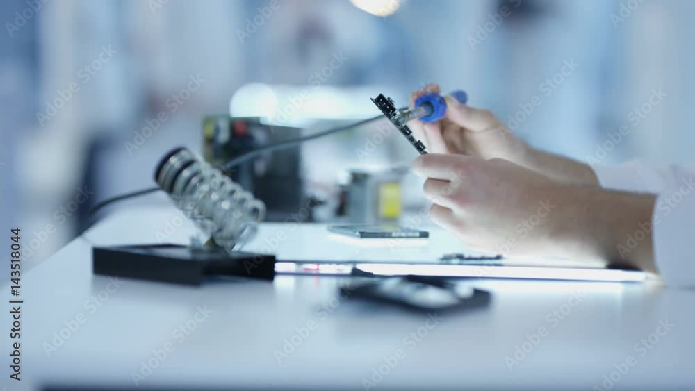 Electronic engineering team working in the lab with 3D printer Electronic engineering team working in the lab with 3D printer
