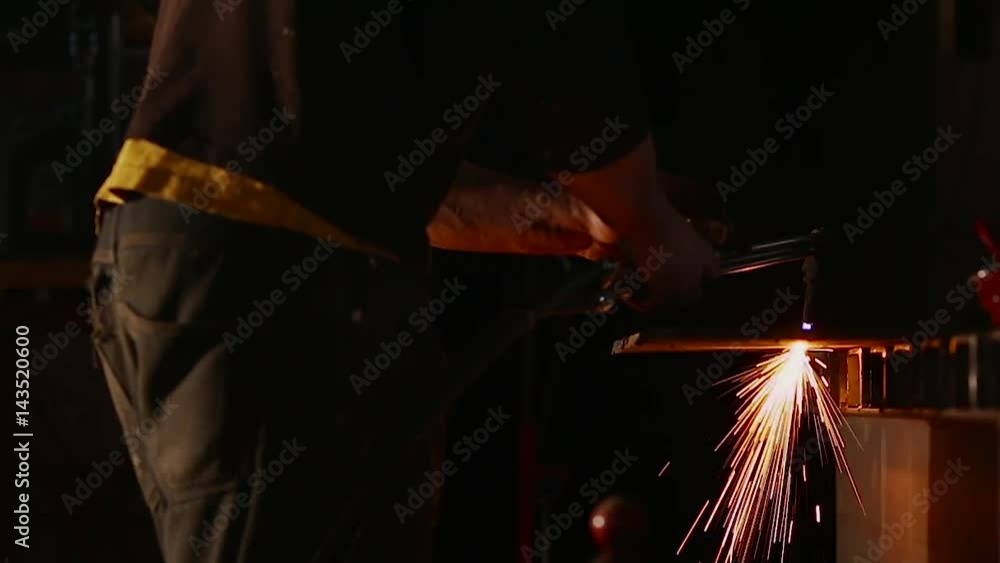 The blacksmith forging the molten metal on the anvil in smithy. close up. The blacksmith forging the molten metal on the anvil in smithy. close up.