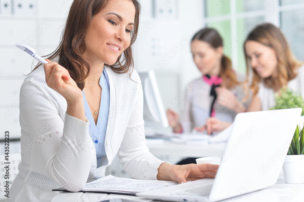 Portrait of a happy business woman using laptop Portrait of a happy business woman using laptop