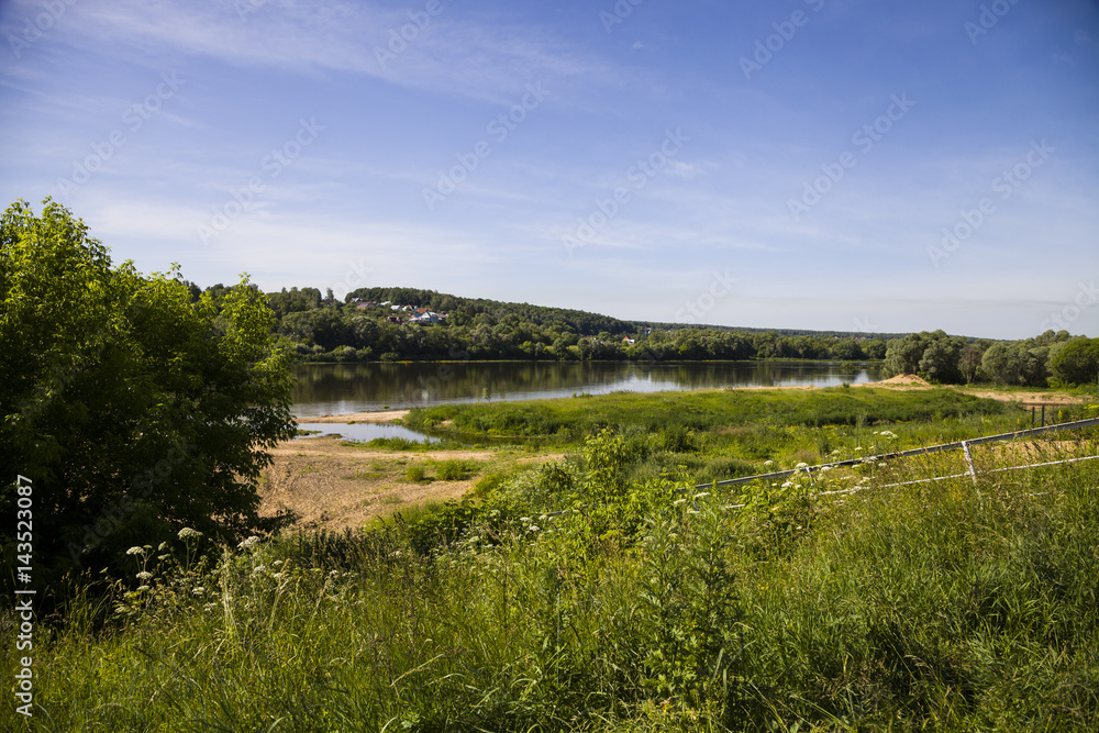 beautiful landscape with a river and a sandy beach on a summer day.