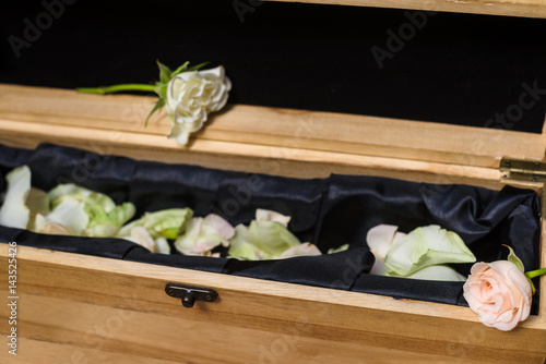 wooden Caskets and rosw petals card photo