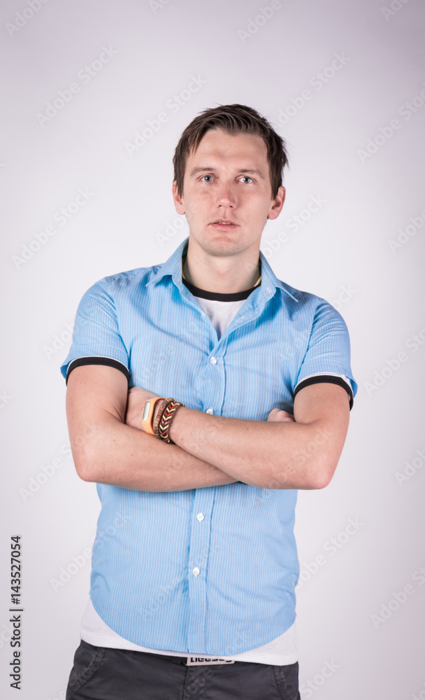 Charming handsome. young man in formalwear With folded arms, looking at camera while standing, white background Charming handsome. young man in formalwear With folded arms, looking at camera while standing, white background