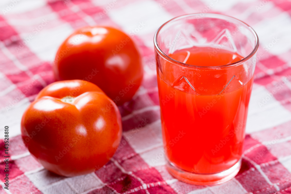 Tomato juice in the glass with fresh tomatos Tomato juice in the glass with fresh tomatos