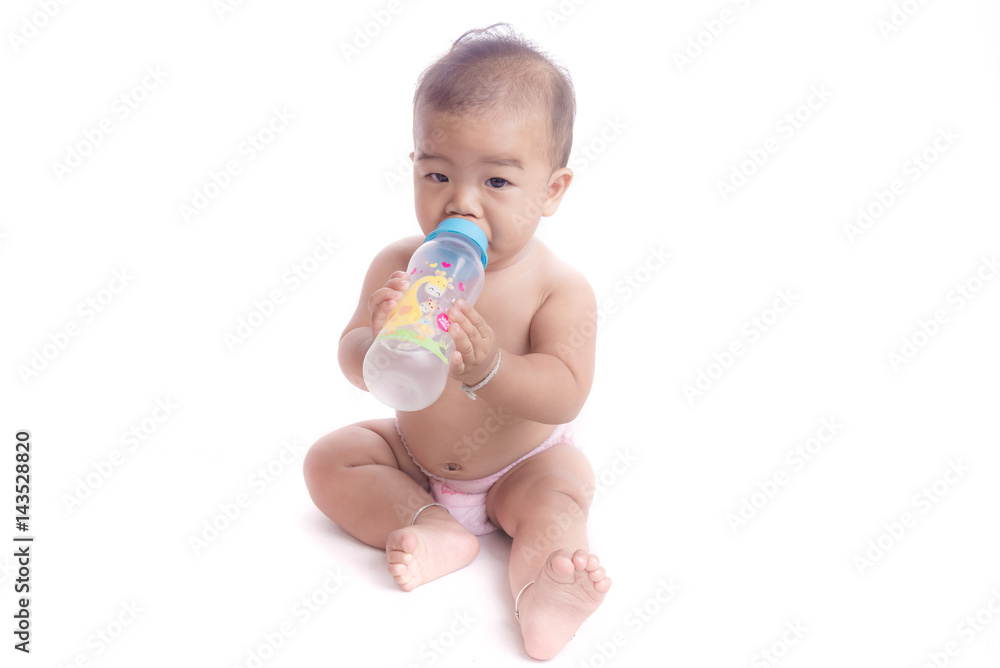 baby tries to suck milk from the bottle. baby tries to suck milk from the bottle.
