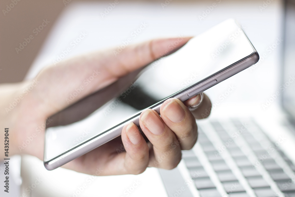 Hand holding mobile smartphone with blank screen. Hand holding mobile smartphone with blank screen.