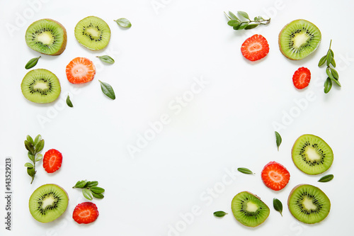 Fruit background of kiwi  strawberries and greens. Flat lay  top view