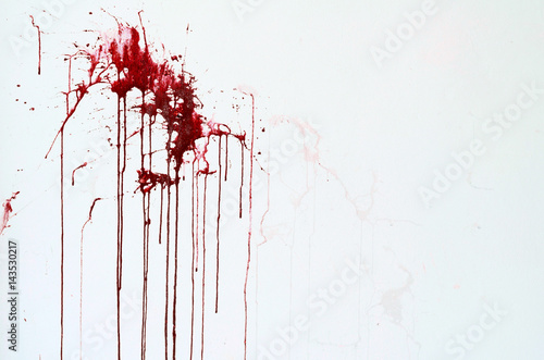 Background texture cement white wall with red blood-like paint streaks photo