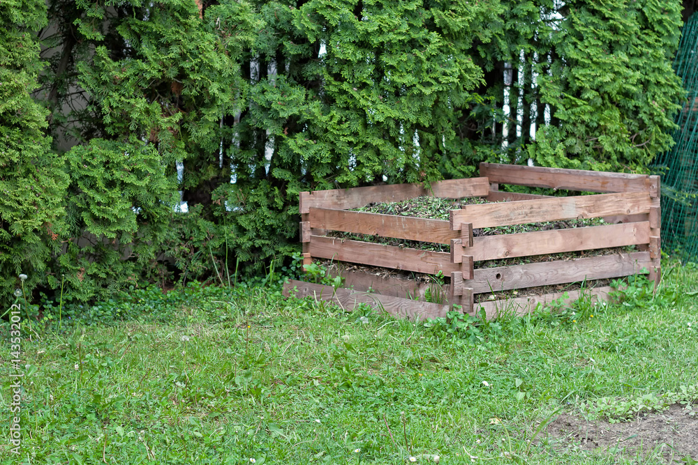 Wooden compost frame in the backyard