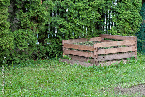 Wooden compost frame in the backyard