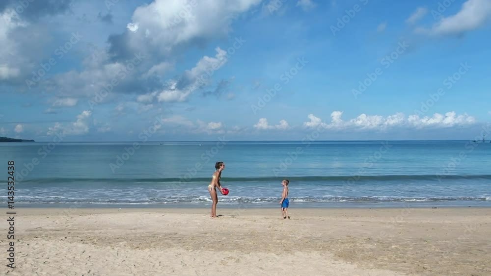 Mother and Son Playing With a Ball on a Beach Mother and Son Playing With a Ball on a Beach