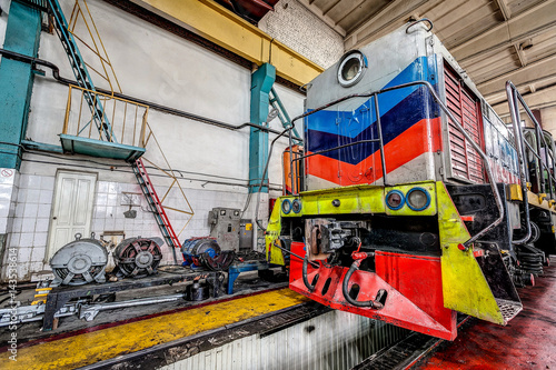 big russian locomotive in the repair workshop for old trains © dobrovizcki