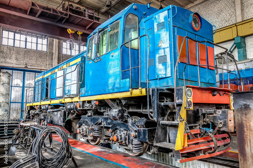 big russian locomotive in the repair workshop for old trains