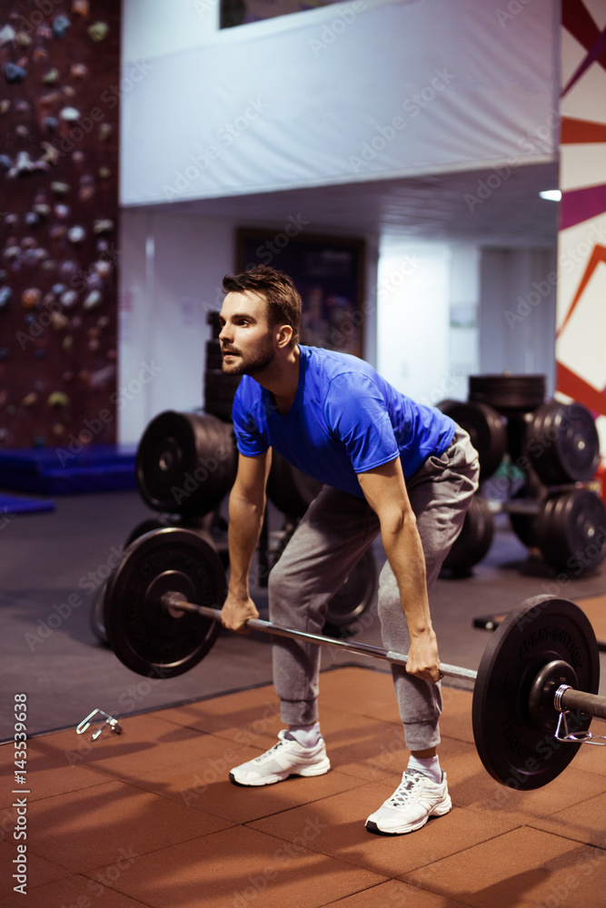 Strong man lifting barbell as a part of crossfit exercise routine. Strong man lifting barbell as a part of crossfit exercise routine.