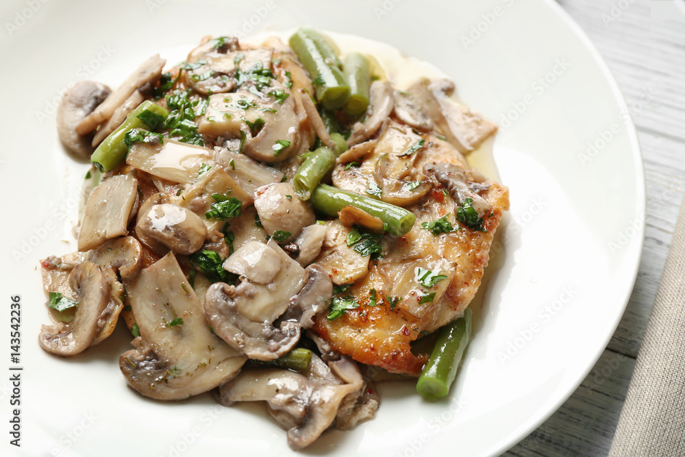 Chicken marsala with mushrooms and French beans on plate, closeup Chicken marsala with mushrooms and French beans on plate, closeup
