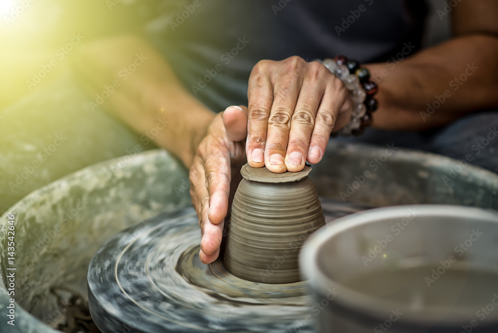 Hands working on pottery wheel Hands working on pottery wheel