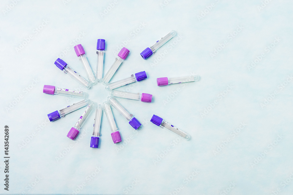 Test tubes for laboratory diagnosis, for blood tests on a blue background . Tubes are arranged in the form of beams or petals of a flower. Test tubes for laboratory diagnosis, for blood tests on a blue background . Tubes are arranged in the form of beams or petals of a flower.