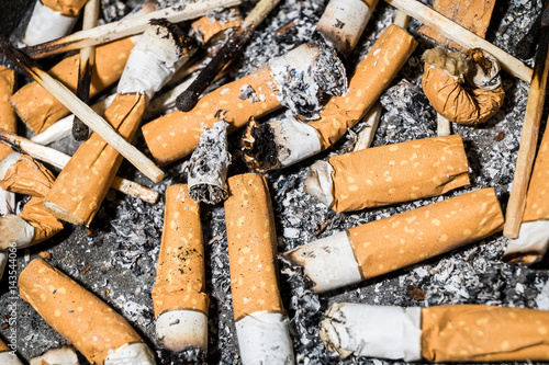 Bad addiction. Ashtray and cigarettes close-up.