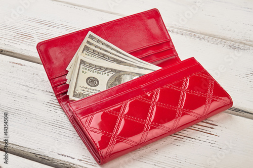 Money in female red leather purse. photo