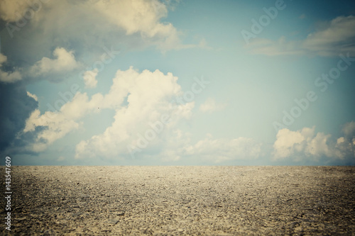 image of asphalt road and clear blue sky with clouds at horizon