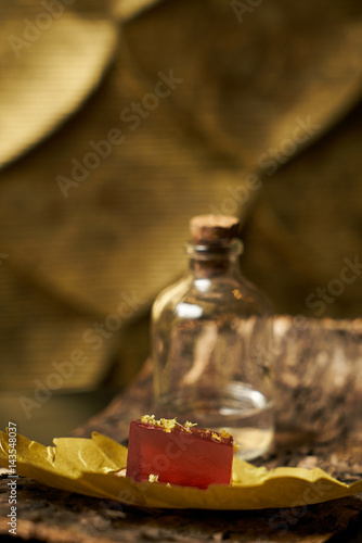 Close up of a piece of lime with marmalade and spices on the bark of a tree. Snack for alcoholic cocktails.