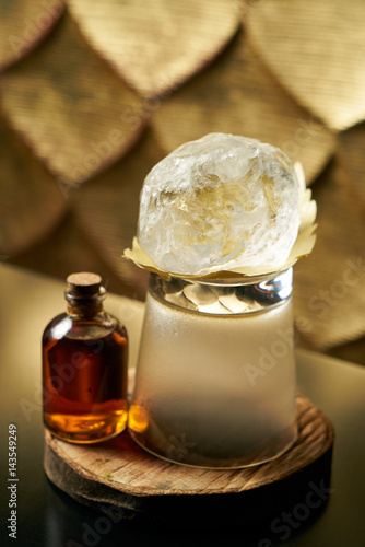 Close-up of a fresh branded alcoholic cocktail with ice and cognac, and smoke in a Whiskey glass on a wooden birch bar counter. Concept of alcoholic and non-alcoholic bar beverage. Copy space.