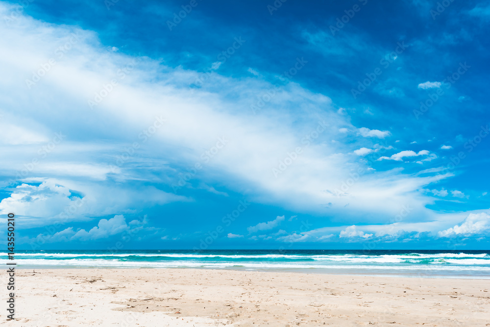 The beutiful view of dark blue sky with white cumulus clouds in hot sunny summer day on the beach in Gold Coast, Australia.