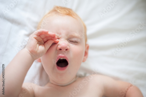 Newborn baby yawns after sleeping