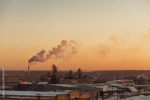 Canvas-taulu Industrial buildings at sunrise