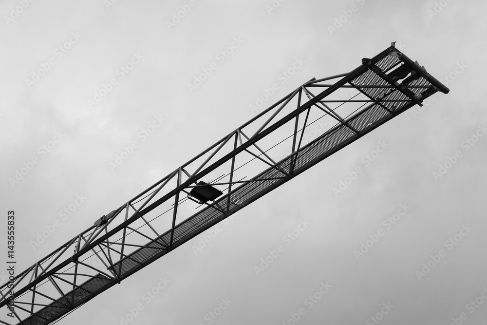 black and white image of Tower crane silhouette construction with heavy industrial black and white image of Tower crane silhouette construction with heavy industrial