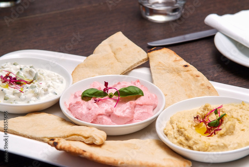 restaurant starter meal of a sharing platter of dips with bread