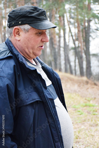 Sad mature man in the forest