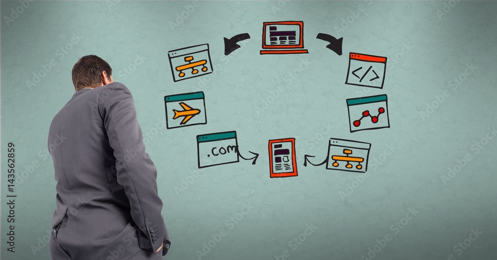Rear view of businessman looking at diagram on wall Rear view of businessman looking at diagram on wall