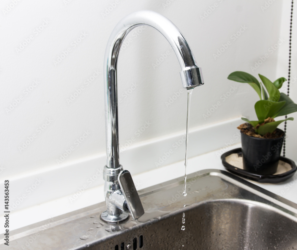 Close up water tap with sink in modern kitchen. Close up water tap with sink in modern kitchen.